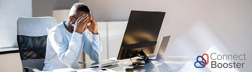 business man looking frustrated while sitting at his computer