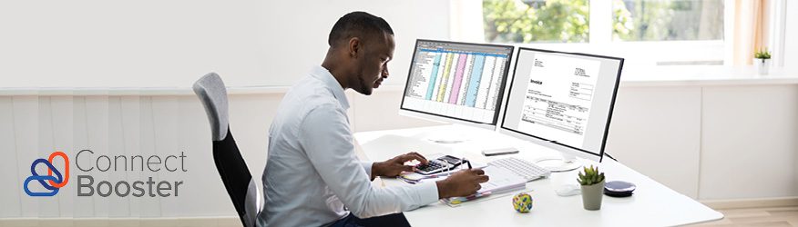 man paying bills while sitting at his computer